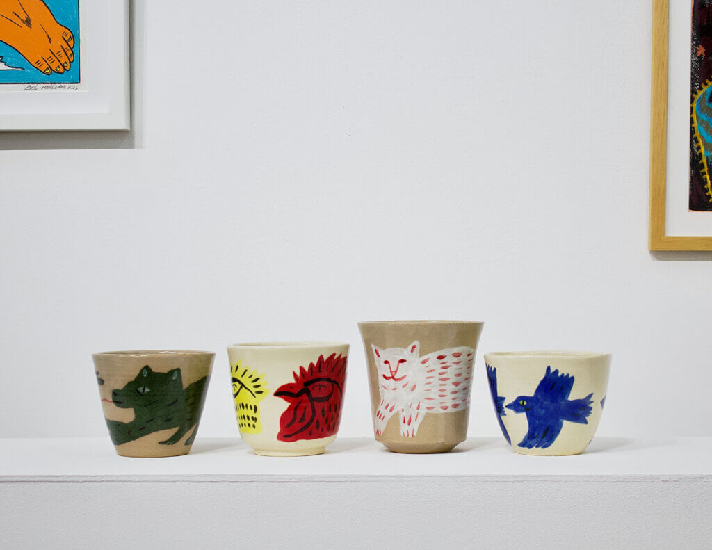 Glazed ceramic plant pots illustrated with animals and figures inspired by travels through Japan, exhibited at Wish Less Gallery in Tokyo.